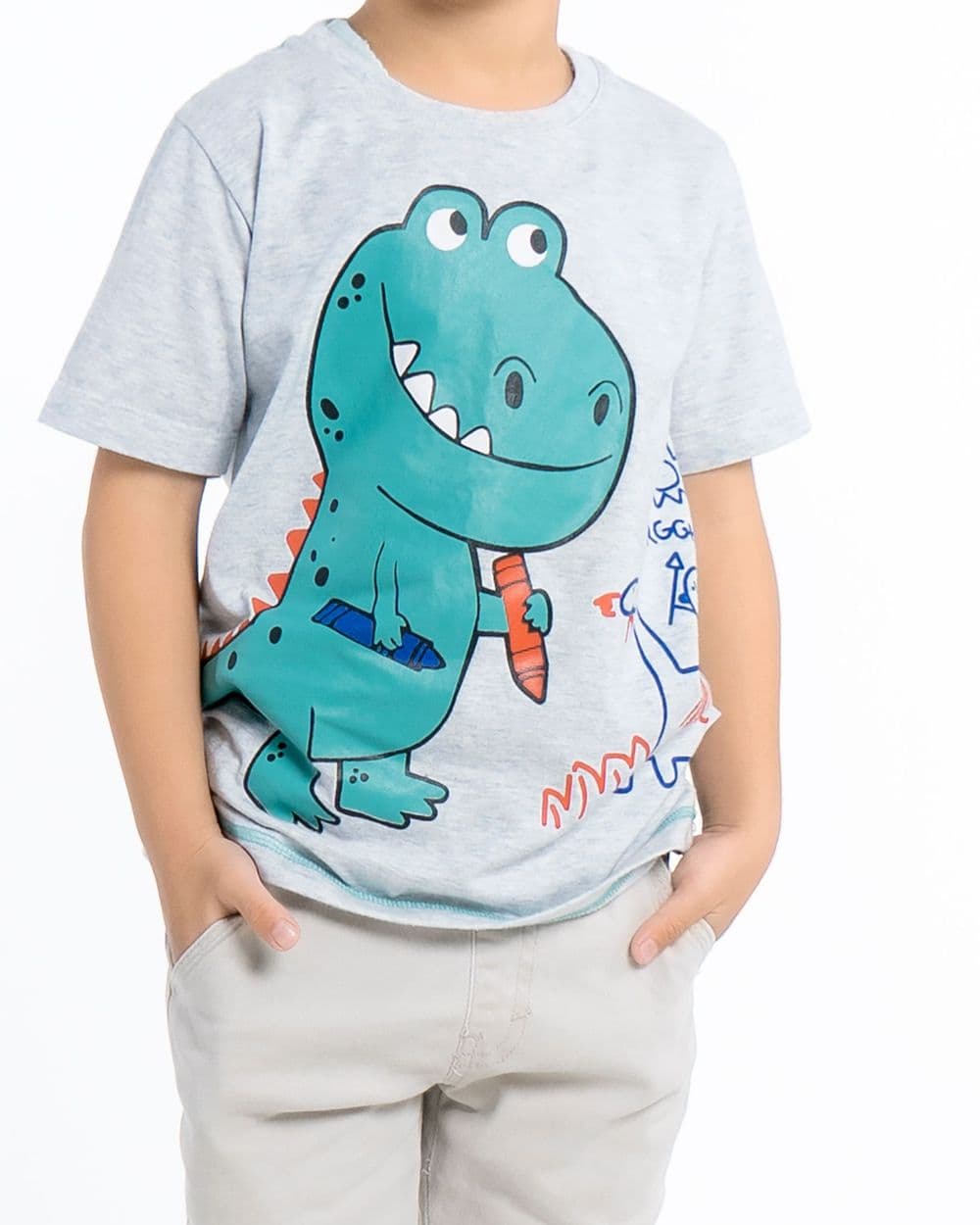 Child wearing a grey t-shirt with a teal cartoon dinosaur print, shown from the chin down